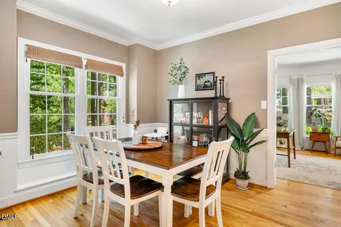 a view of a dining room with furniture window and wooden floor