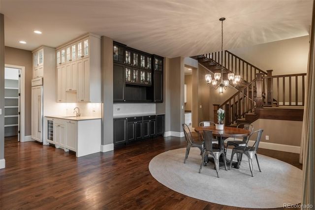 a dining room with furniture a chandelier and wooden floor