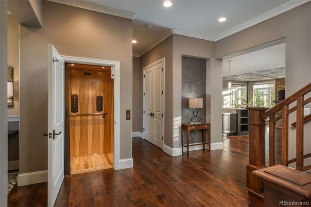 a view of a hallway with wooden floor windows and a livingroom