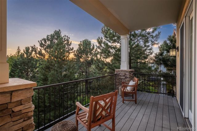 a view of a balcony with wooden floor and outdoor seating