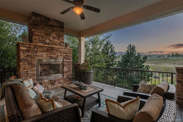 a roof deck with a table and chairs