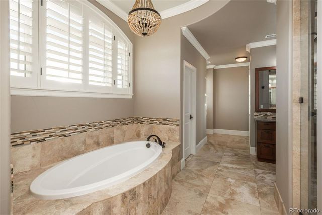 a bathroom with a tub and a shower