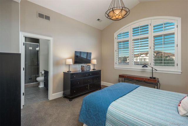 a bedroom with a bed and a tv on the dresser