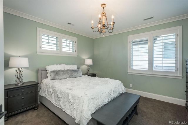 a bedroom with a bed and a chandelier