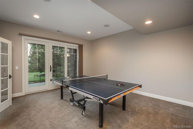 a room with pool table and windows