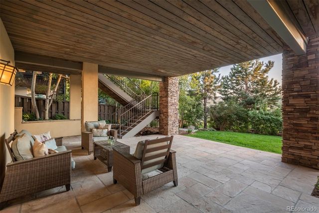 a view of a couches in the patio and a couple of the trees