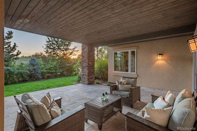 a view of patio with couches and pool