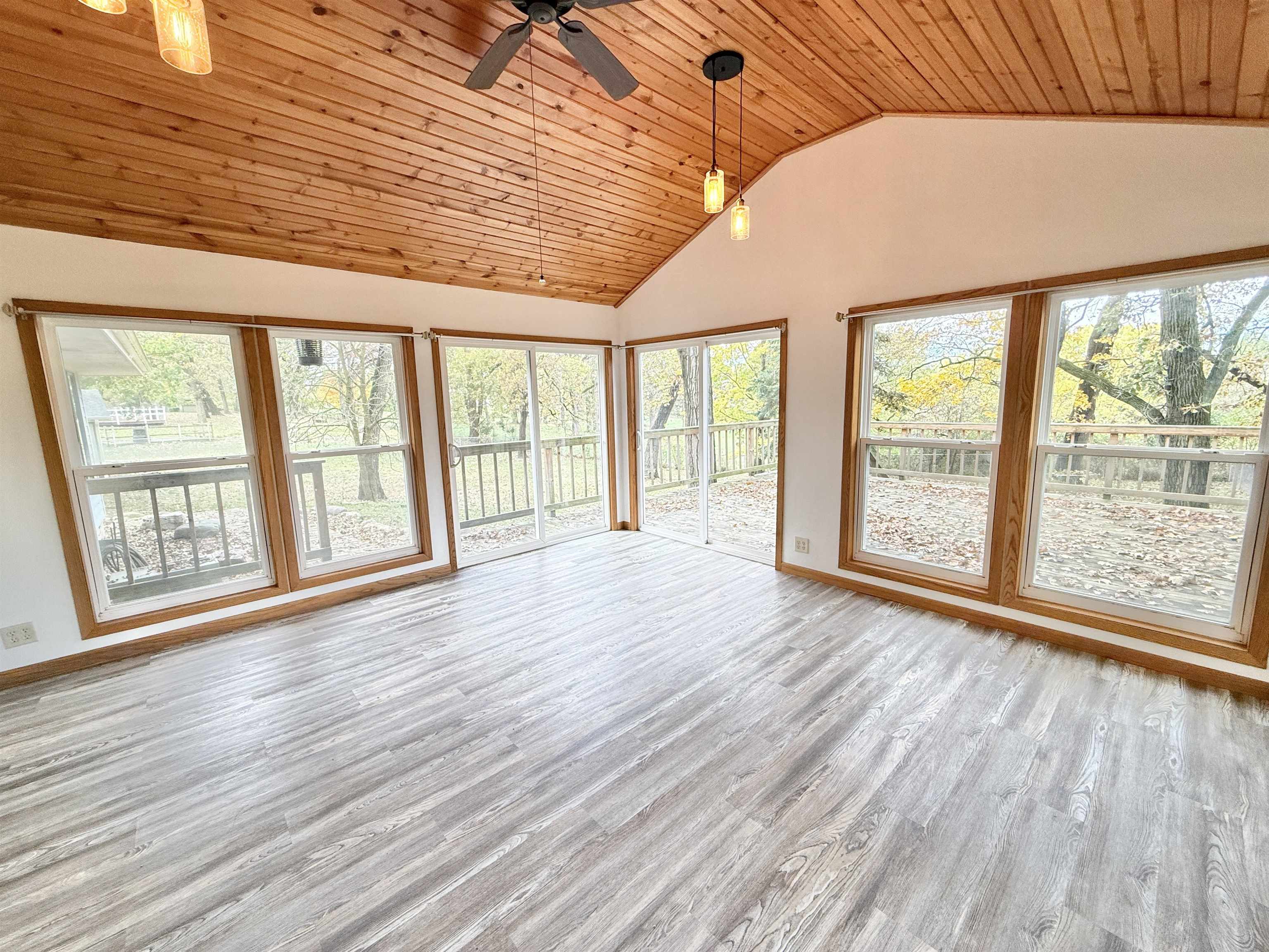 10620 Grover Oaks Road Roscoe, IL 61073 - Photo 23 of 32 a view of an empty room with wooden floor and a window