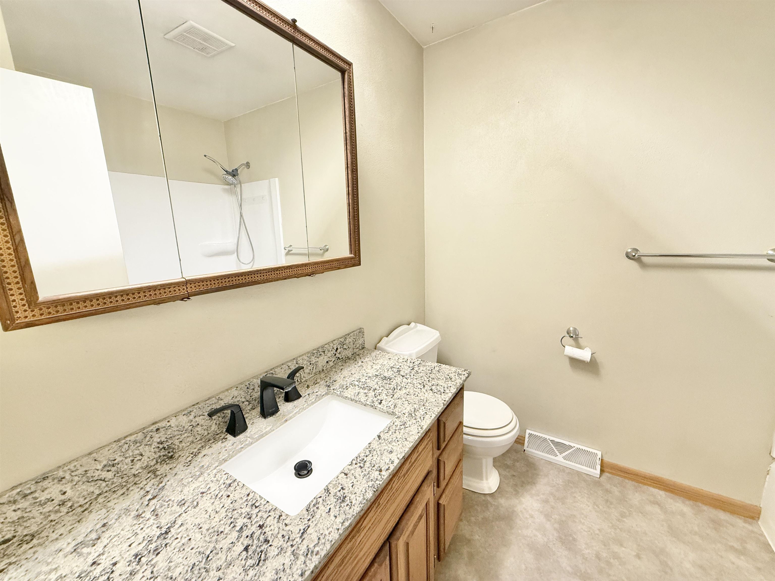 10620 Grover Oaks Road Roscoe, IL 61073 - Photo 26 of 32 a bathroom with a granite countertop sink a large mirror and a toilet