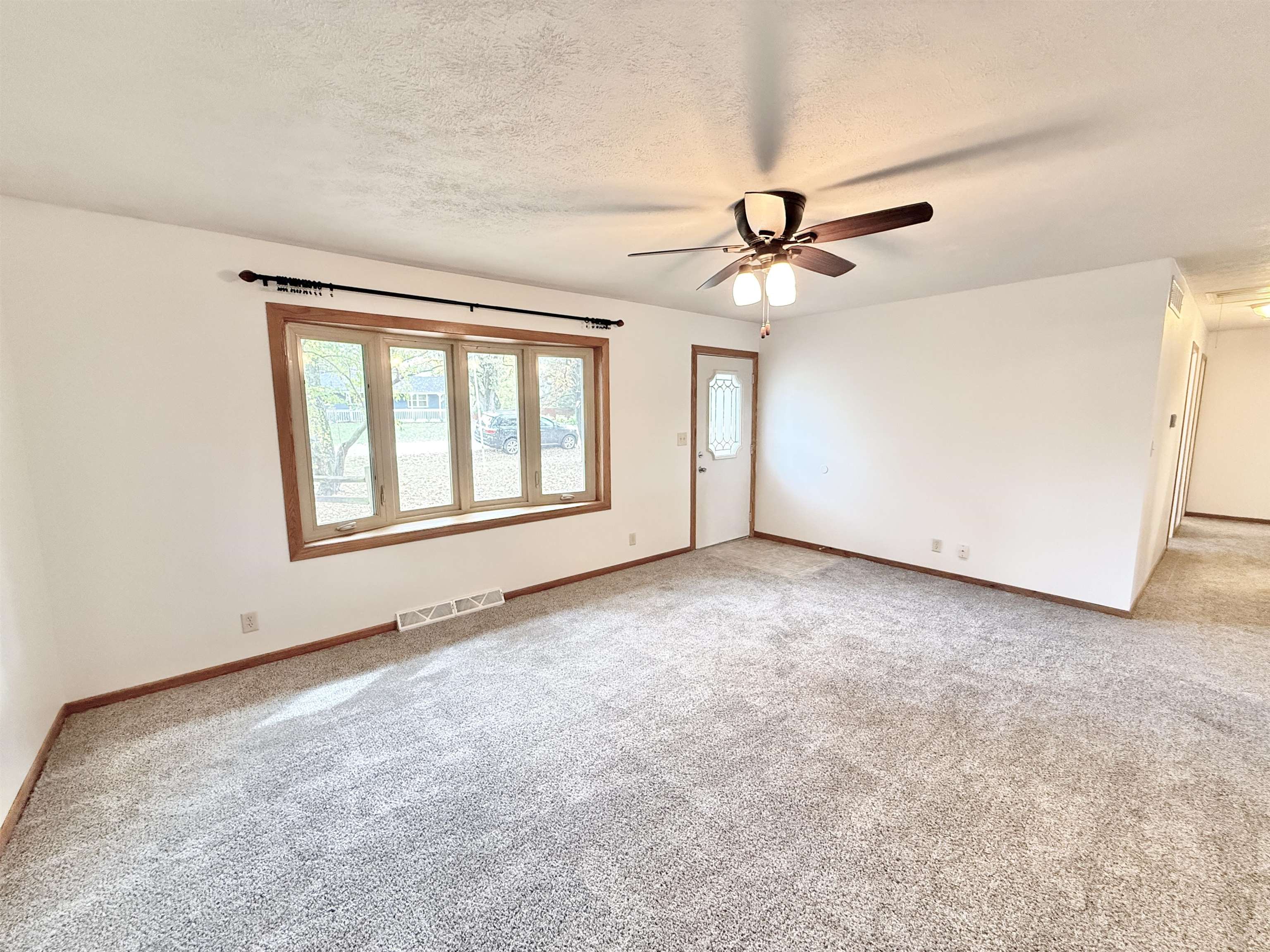 10620 Grover Oaks Road Roscoe, IL 61073 - Photo 5 of 32 an empty room with windows and fan