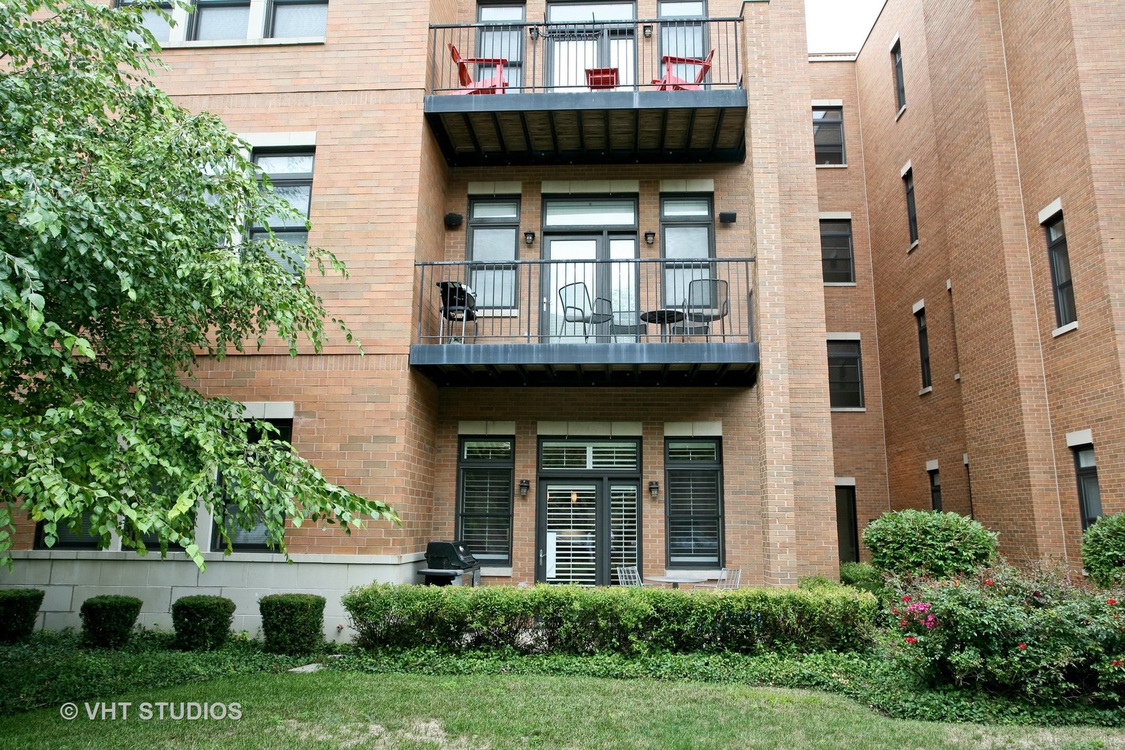 821 Foster Street, Unit 1S Evanston, IL 60201 - Photo 1 of 14 a front view of a house with garden