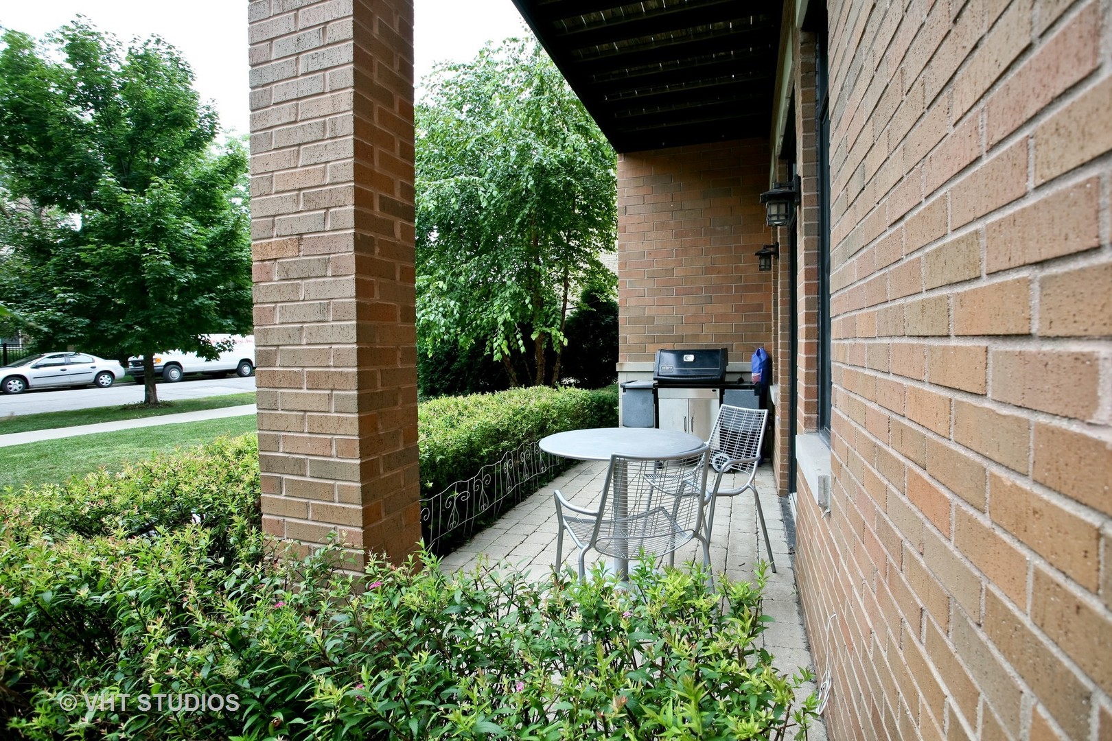 821 Foster Street, Unit 1S Evanston, IL 60201 - Photo 13 of 14 a view of a bench in the backyard of the house