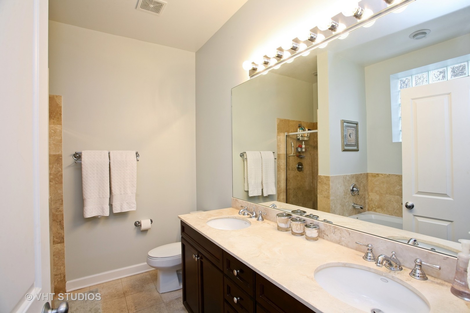 821 Foster Street, Unit 1S Evanston, IL 60201 - Photo 9 of 14 a bathroom with a sink double vanity and a toilet