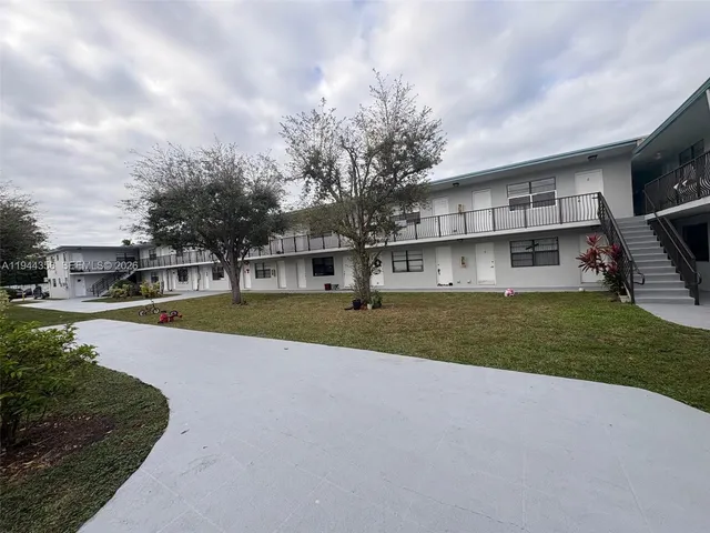 a view of house with outdoor space and sitting area