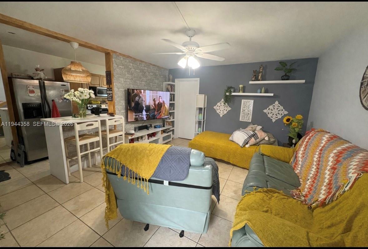 4444 Southwest 67th Avenue, Unit 6 Miami, FL 33155 - Photo 3 of 7 a living room with furniture and a chandelier