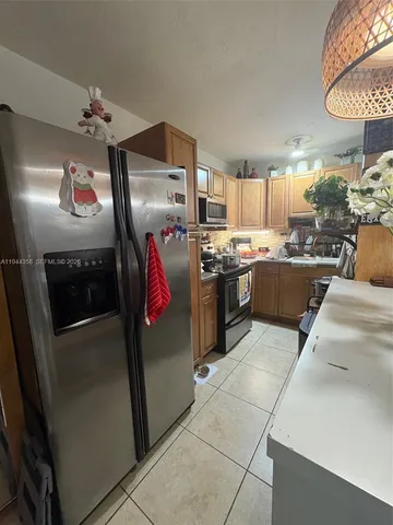 a kitchen with refrigerator and window