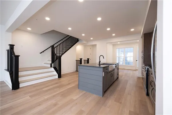 a view of living room with wooden floor and staircase