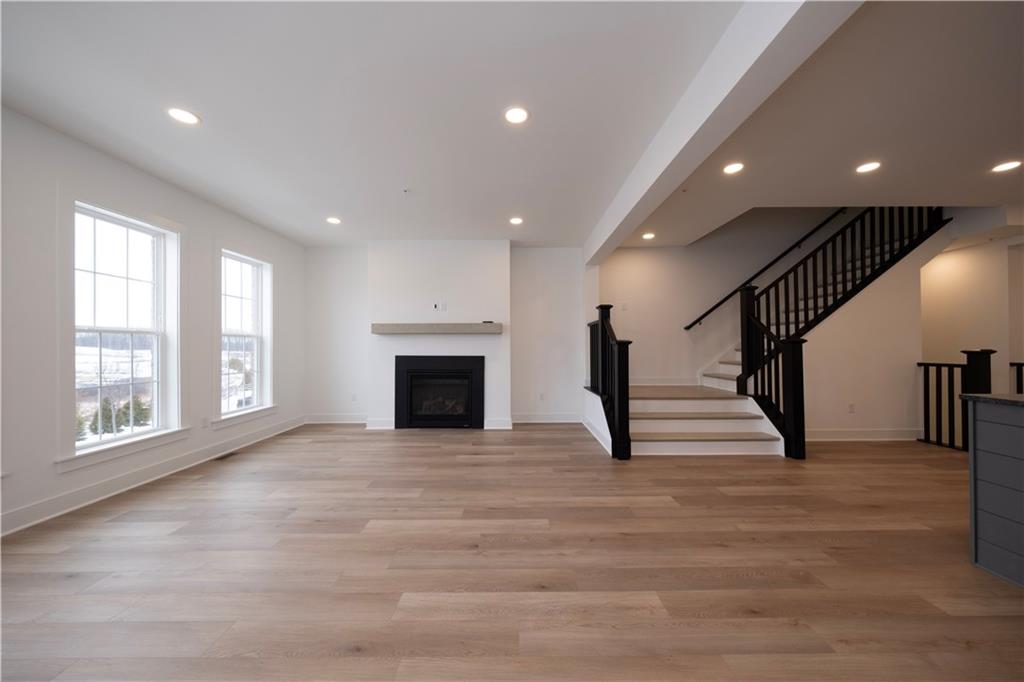 405 Ramsgate Road Cranberry Township, PA 16066 - Photo 16 of 50 a view of an empty room with wooden floor and a fireplace