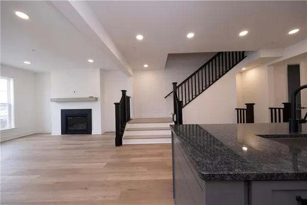 a view of entryway and hall with wooden floor