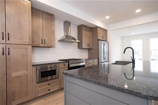 a kitchen with granite countertop a sink and a stove
