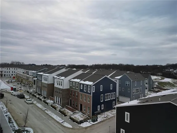 an aerial view of a houses with a city