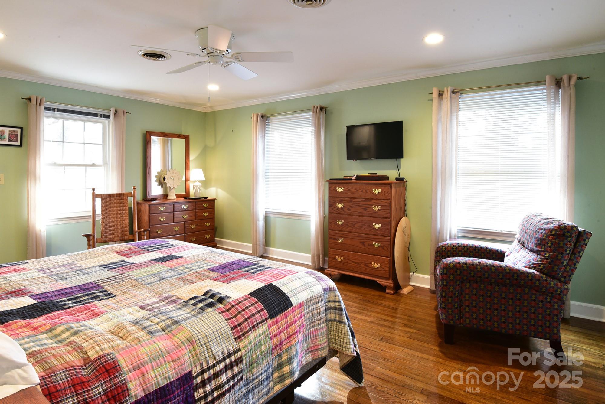 215 Biscoe Road Troy, NC 27371 - Photo 11 of 33 a bedroom with a bed and wooden floor