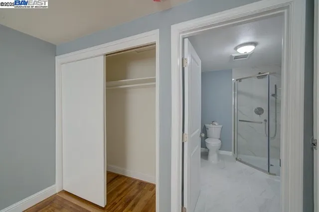 a view of bathroom with a toilet sink and a mirror