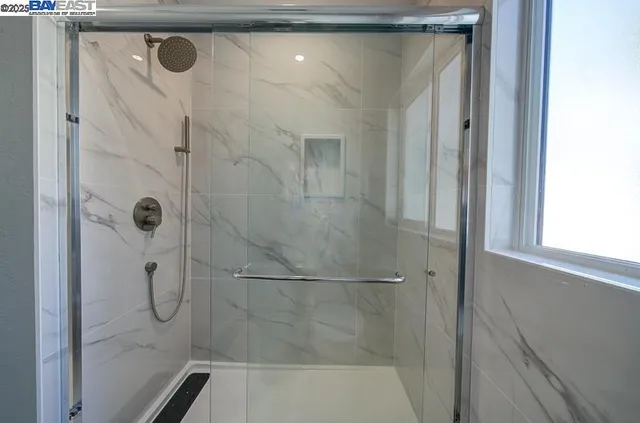 a bathroom with a glass shower door