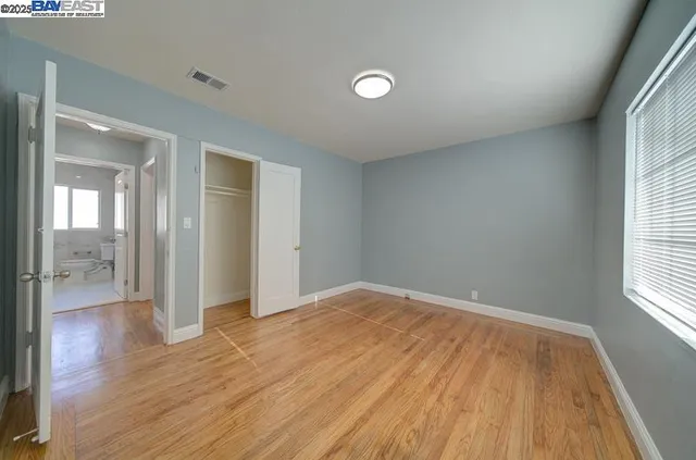 wooden floor in an empty room with a window