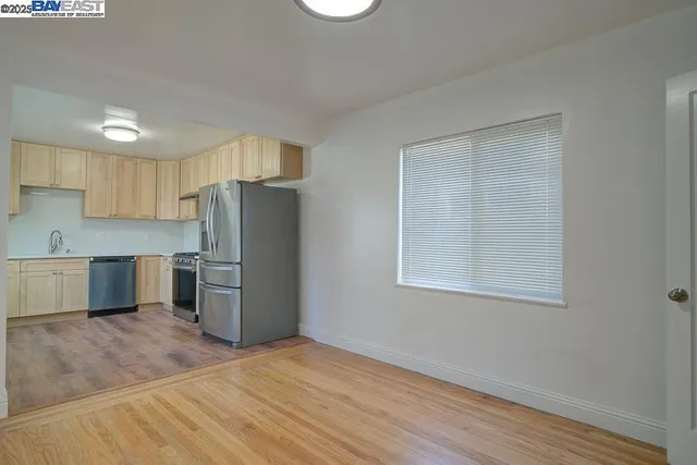 a kitchen with stainless steel appliances a refrigerator and a sink