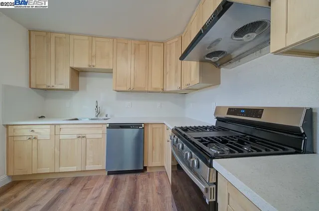 a kitchen with granite countertop a stove and a sink