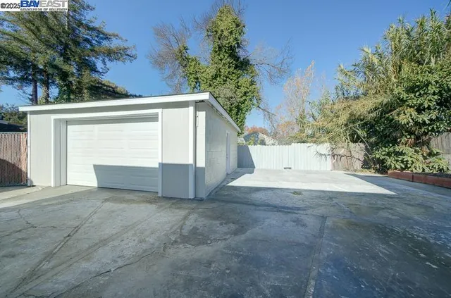 a view of white house with a yard and garage