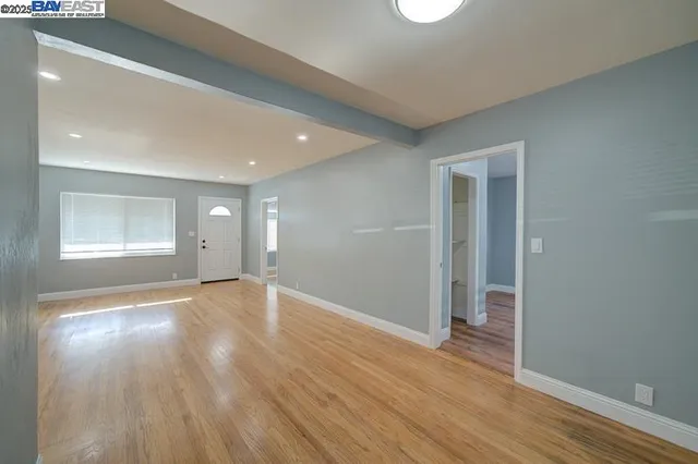 wooden floor in an empty room with a window
