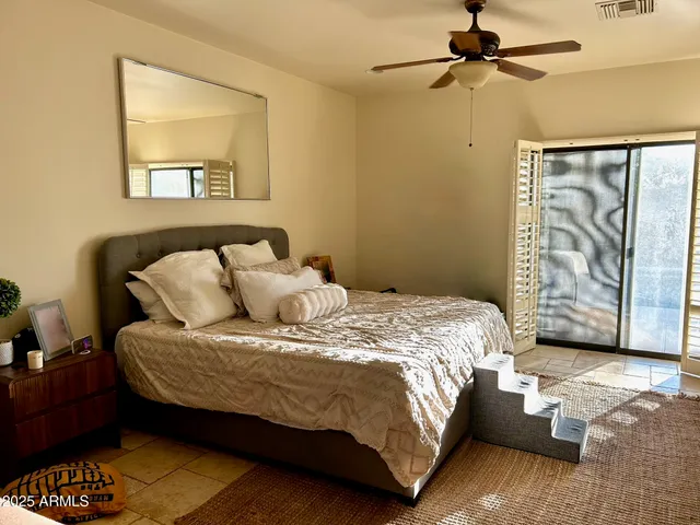 a living room with patio furniture and a floor to ceiling window