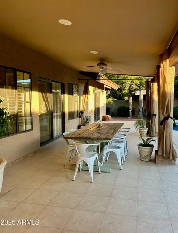 a view of a roof deck with couches wooden fence and floor
