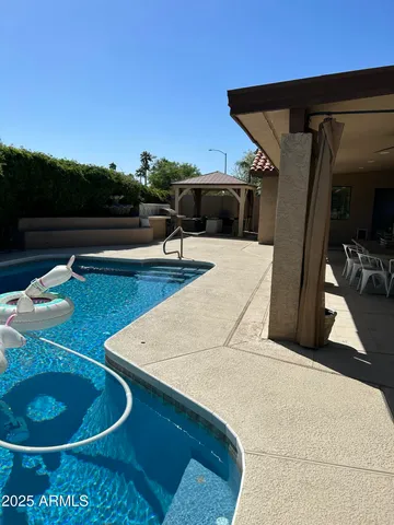 a view of a house with backyard and porch