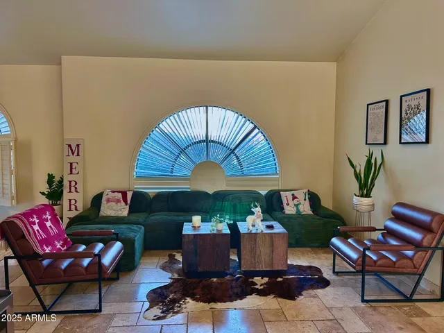 a view of a livingroom with furniture and a window