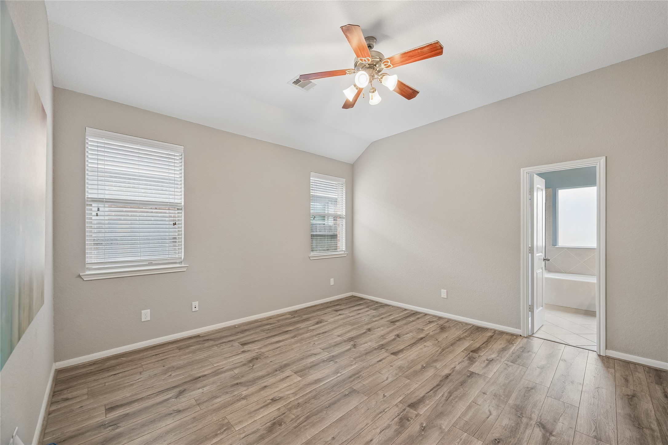 13006 Millstream Bend Lane Tomball, TX 77377 - Photo 12 of 25 wooden floor in an empty room with a window