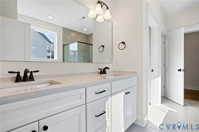 a bathroom with a sink a light fixture and a mirror