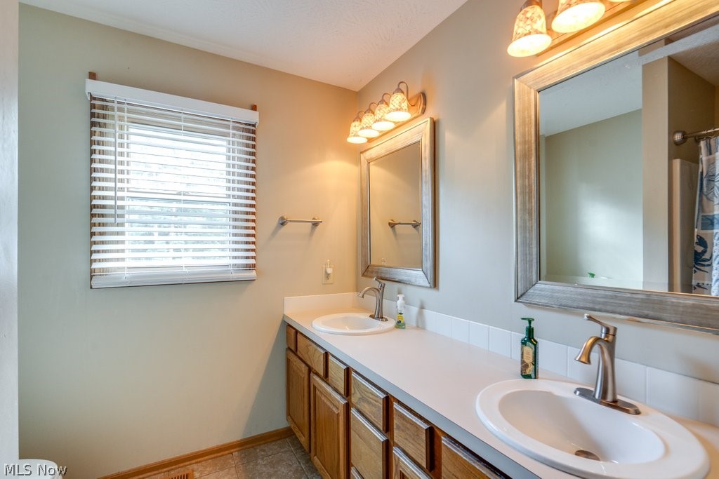 826 Stewart Road Kent, OH 44240 - Photo 38 of 43 Bathroom featuring dual vanity, tile patterned floors, and toilet