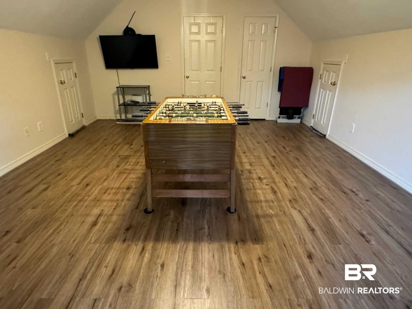 31163 Woodland Way Daphne, AL 36527 - Photo 33 of 44 Recreation room with vaulted ceiling and dark hardwood / wood-style floors