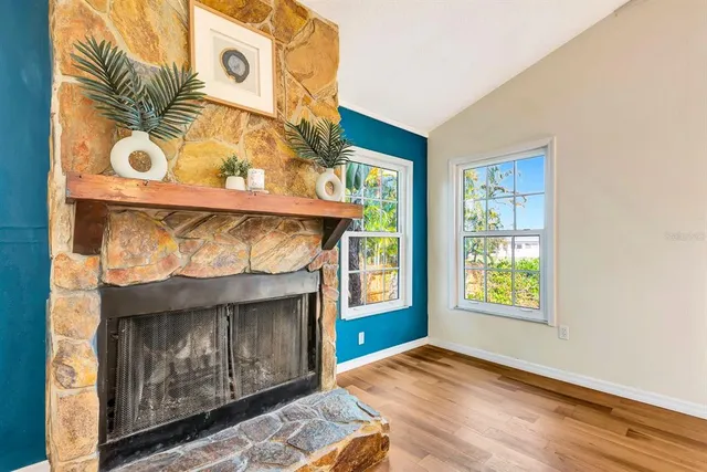 a kitchen with stainless steel appliances kitchen island granite countertop a stove a sink dishwasher and a refrigerator with wooden floor