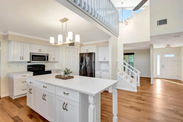a kitchen with a stove a sink and a refrigerator