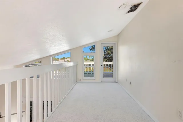 a spacious bedroom with a large bed and a dresser