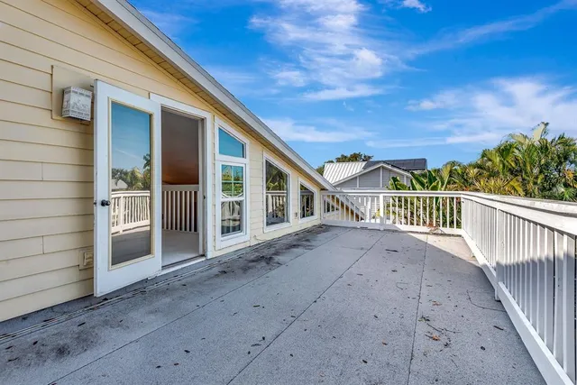 a spacious bathroom with a granite countertop sink and a bathtub