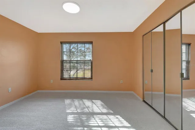 a view of room with window and a ceiling fan