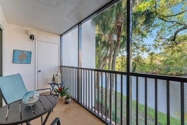a view of a porch with furniture and a yard
