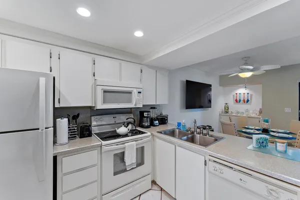 a kitchen with stainless steel appliances white cabinets and a refrigerator