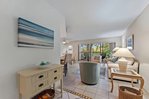 a living room with furniture a window and a table