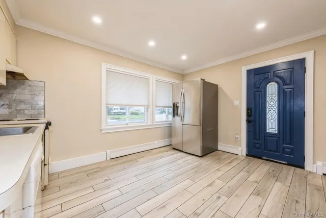 a view of empty room with wooden floor and window